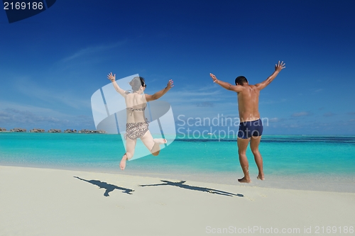 Image of happy young  couple enjoying summer on beach