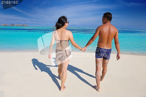 Image of happy young  couple enjoying summer on beach