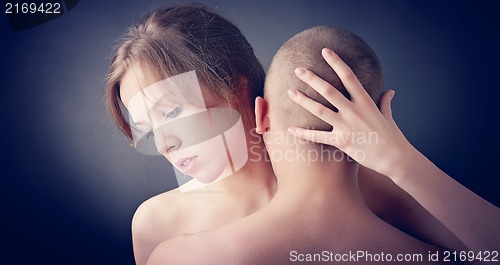 Image of Muscular man and topless girl