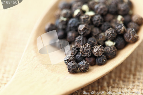 Image of pepper in wooden spoon