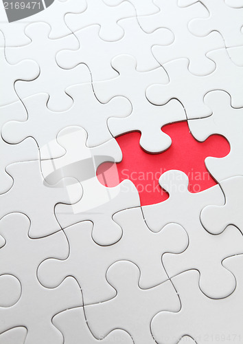Image of puzzle with missing red piece