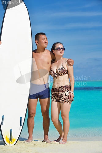 Image of happy young  couple enjoying summer on beach