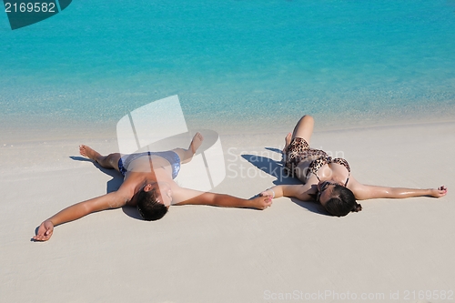 Image of happy young  couple enjoying summer on beach