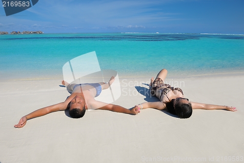 Image of happy young  couple enjoying summer on beach