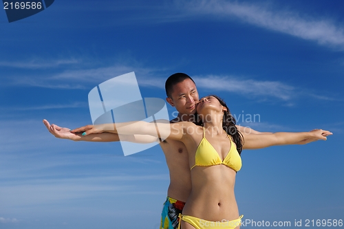 Image of happy young  couple enjoying summer on beach
