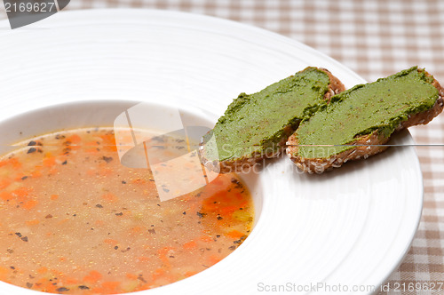 Image of Italian minestrone soup with pesto crostini on side