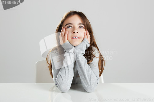 Image of Little girl in a desk