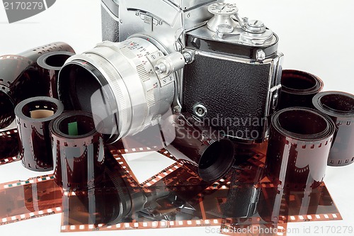 Image of analog vintage SLR camera and color negative films