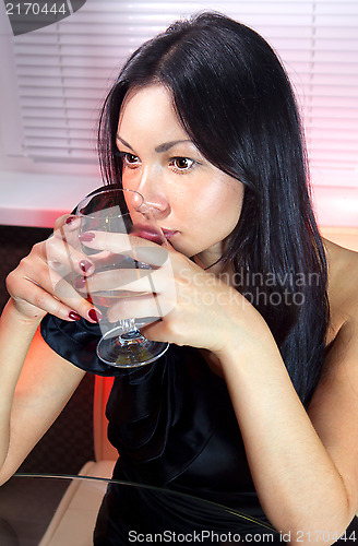 Image of woman with glass of brandy ll