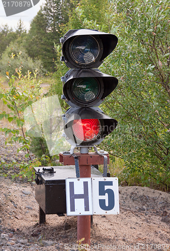 Image of Traffic light shows red signal on railway. Railway station.