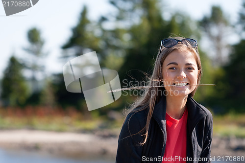 Image of beautiful girl with an ear in his teeth against the backdrop of 