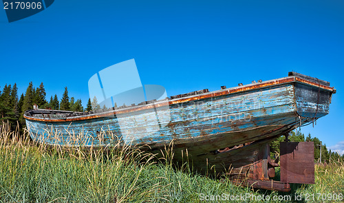 Image of beached fishing trawler to give a well worn vintage look