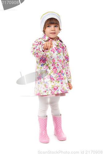 Image of little girl in boots and a jacket shows finger