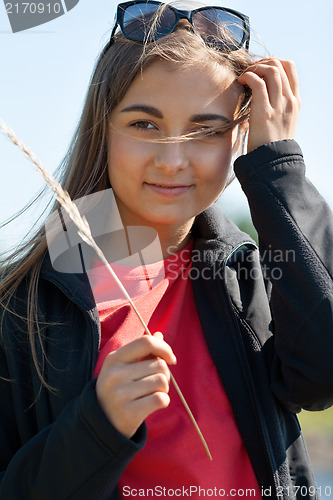 Image of Portrait of a beautiful woman in sunglasses with ear
