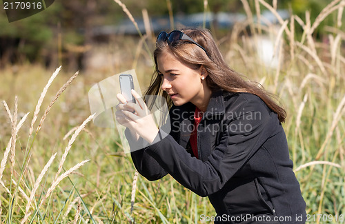 Image of pictures of a girl ear to the phone