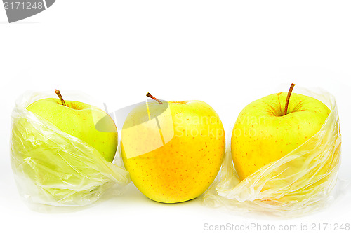 Image of Group of three unpeeled apples on a white background