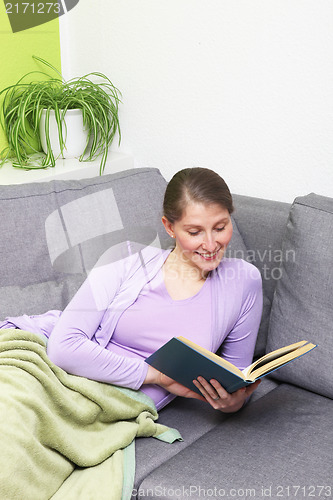 Image of Happy woman reading a book