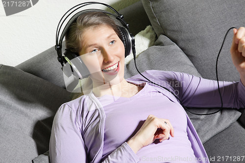 Image of Middle-aged woman enjoying music