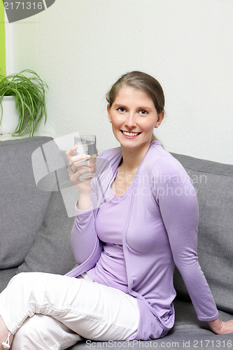 Image of Happy healthy woman drinking water