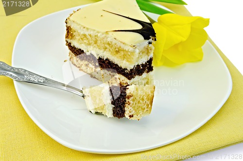 Image of Cake with yellow tulip on a napkin