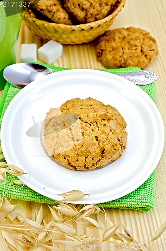 Image of Biscuits with stalks of oats on a wooden board