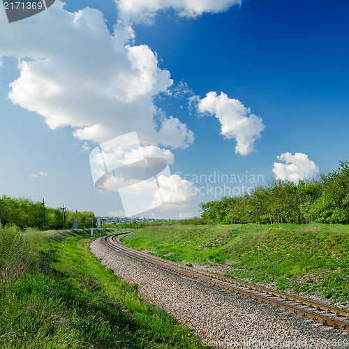 Image of railway goes to horizon in green landscape