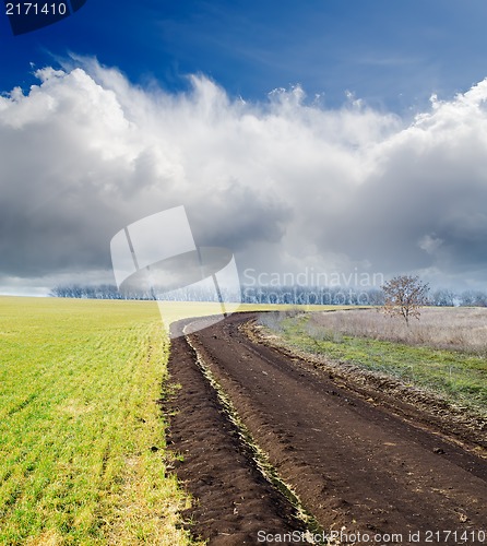 Image of dirty road to cloudy horizon