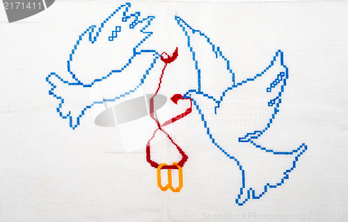 Image of White doves holding wedding rings