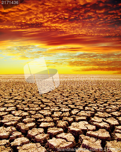 Image of drought land under red clouds