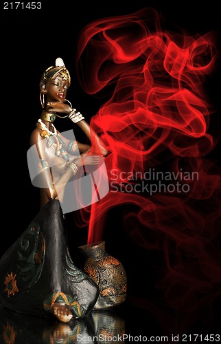 Image of  Figurine of the African girl on a black background