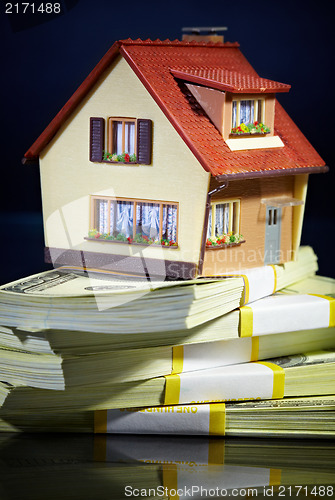 Image of house on packs of banknotes