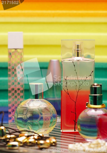 Image of Glass bottles with perfumery. On a color background with reflect