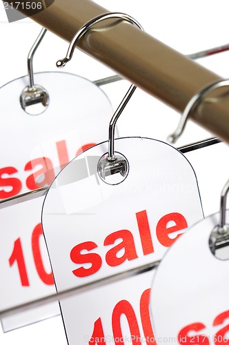 Image of Sale. A hanger with labels on a white background.