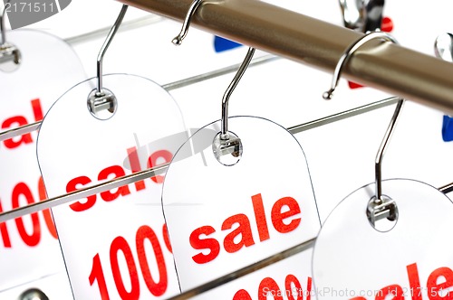 Image of Sale. A hanger with labels on a white background.