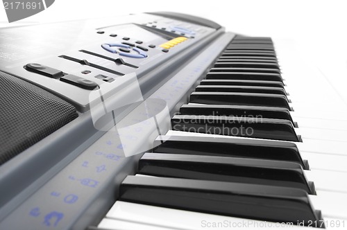 Image of Keys of a synthesizer in white bright light.