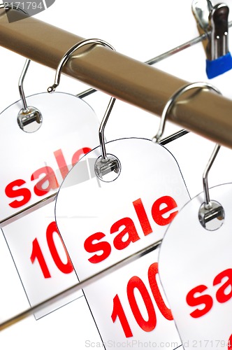 Image of Sale. A hanger with labels on a white background.