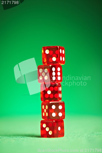 Image of red dices on green cloth