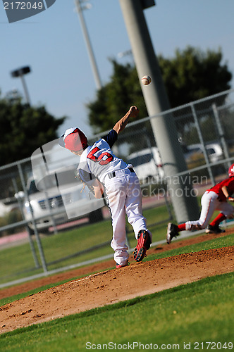 Image of Little league pitcher throwing to first