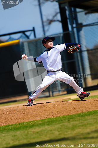 Image of Little league pitcher in white jersey