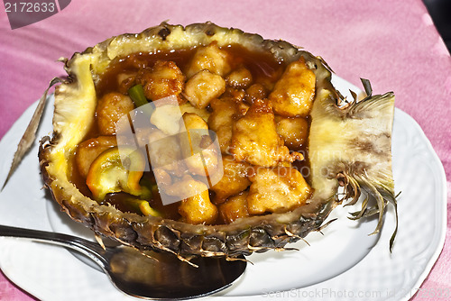 Image of Chinese chicken sweet and sour sauce inside pineapple