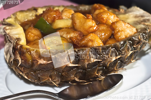 Image of Chinese chicken sweet and sour sauce inside pineapple