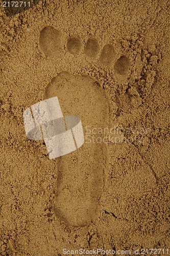 Image of foot print in the sand 