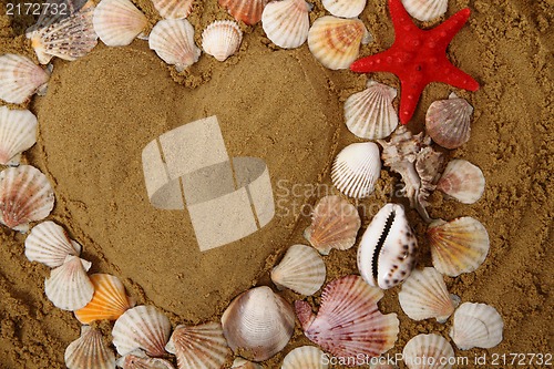 Image of heart from the sea shells and sand