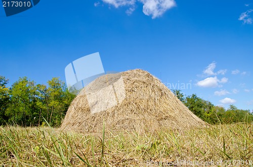 Image of stack of straw under deep blue sky