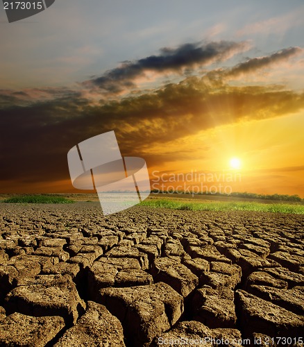 Image of sunset over cracked earth