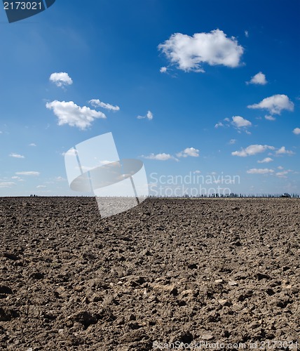 Image of black field under deep blue sky