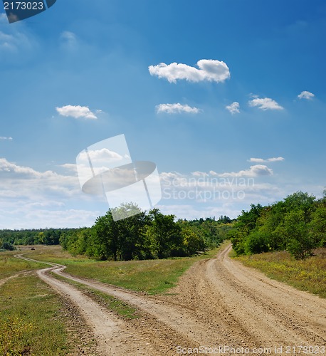 Image of two rural roads go to horizon under cloudy sky