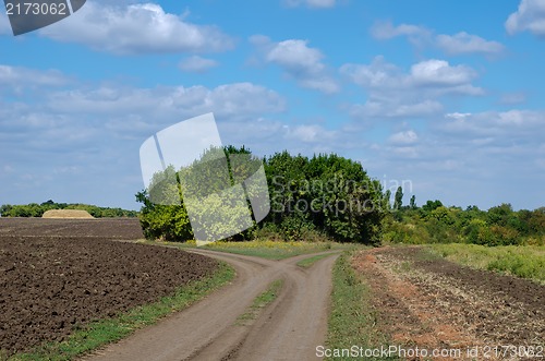 Image of two roads under sky with clouds