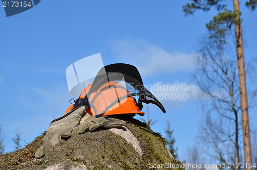 Image of Helmet and gloves on a rock