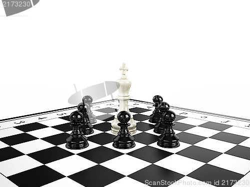 Image of White chess king surrounded by black chess pawns on a chessboard